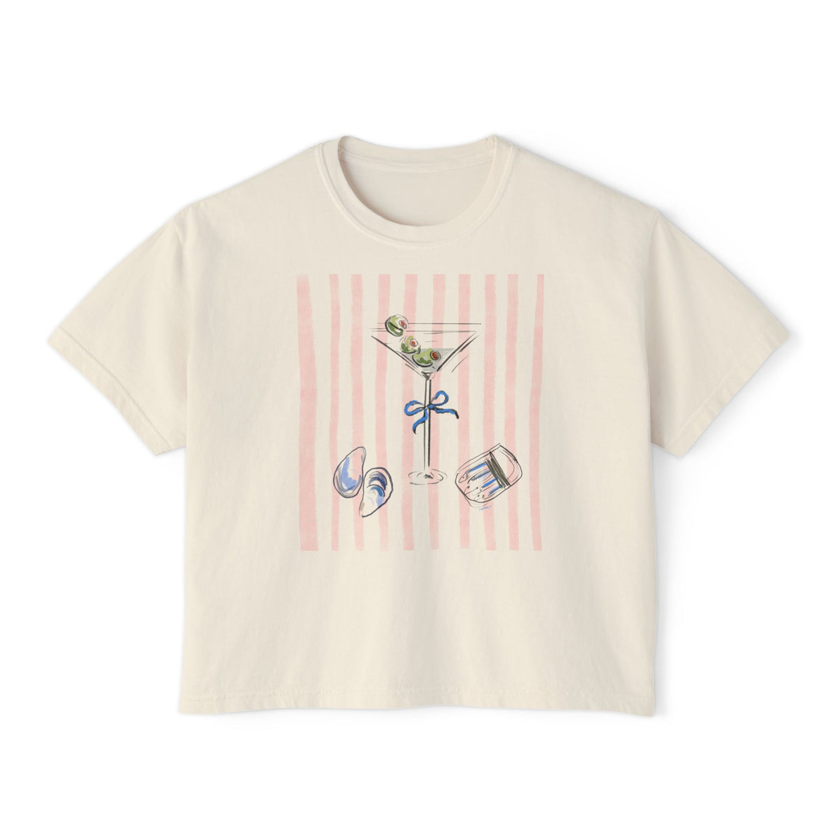 Cream-colored cropped t-shirt featuring a hand-drawn martini glass with olives, pastel pink vertical stripes, seashells, and cocktail ice illustration by Rebecca Illustrated.