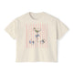 Cream-colored cropped t-shirt featuring a hand-drawn martini glass with olives, pastel pink vertical stripes, seashells, and cocktail ice illustration by Rebecca Illustrated.