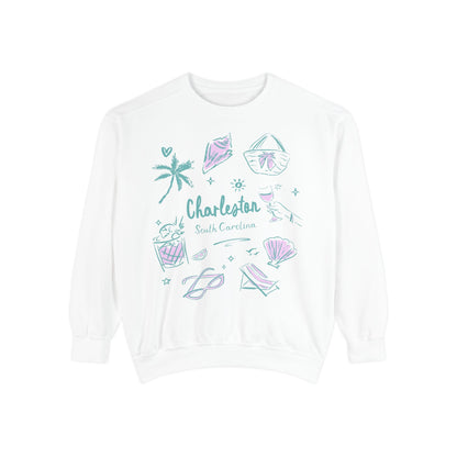 White Charleston South Carolina sweatshirt with pastel coastal illustrations including seashells, palm tree, beach drink, lounge chair, and artwork by Rebecca Illustrated