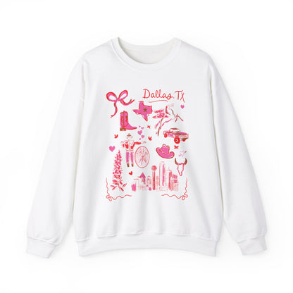 White sweatshirt with pink and green illustrated Dallas, Texas icons including cowboy boots, Texas map, longhorn, skyline, flowers, cowgirl, bike, and truck, artwork by Rebecca Illustrated
