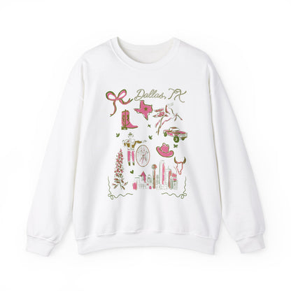 White sweatshirt with pink and green illustrated Dallas, Texas icons including cowboy boots, Texas map, longhorn, skyline, flowers, cowgirl, bike, and truck, artwork by Rebecca Illustrated