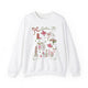 White sweatshirt with pink and green illustrated Dallas, Texas icons including cowboy boots, Texas map, longhorn, skyline, flowers, cowgirl, bike, and truck, artwork by Rebecca Illustrated