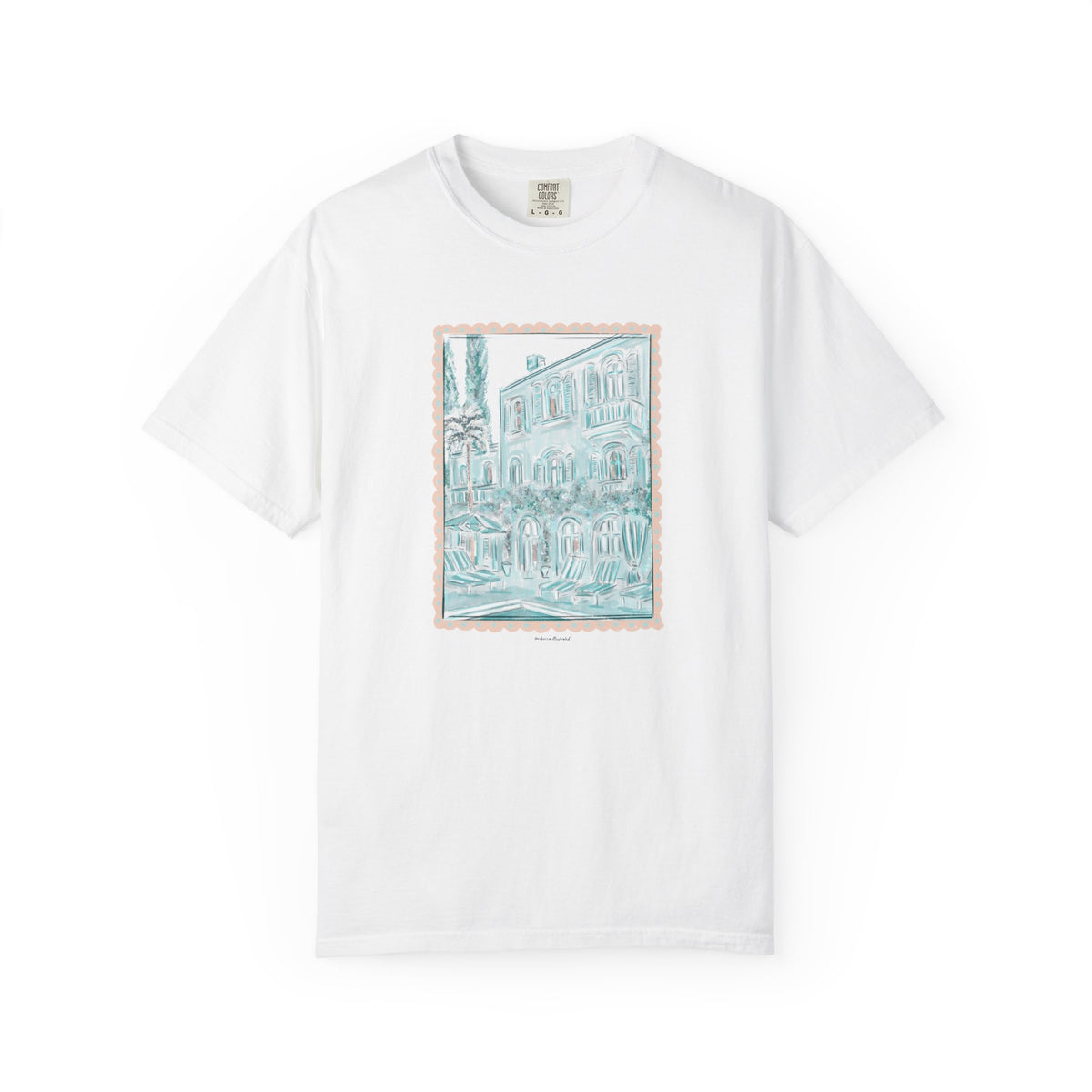White t-shirt featuring a hand-drawn architectural illustration in teal of a European-style villa framed with a scalloped border, created by Rebecca Illustrated.