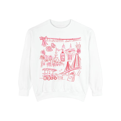 White sweatshirt featuring red illustrated Charleston South Carolina landmarks including bridge, pineapples, buildings, horse carriage, and artwork by Rebecca Illustrated