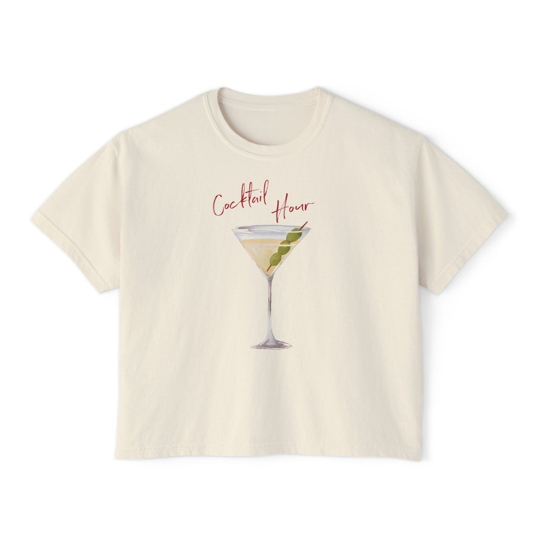 Cream t-shirt featuring a hand-drawn martini cocktail with olives and the words “Cocktail Hour,” illustrated by artist Rebecca Illustrated