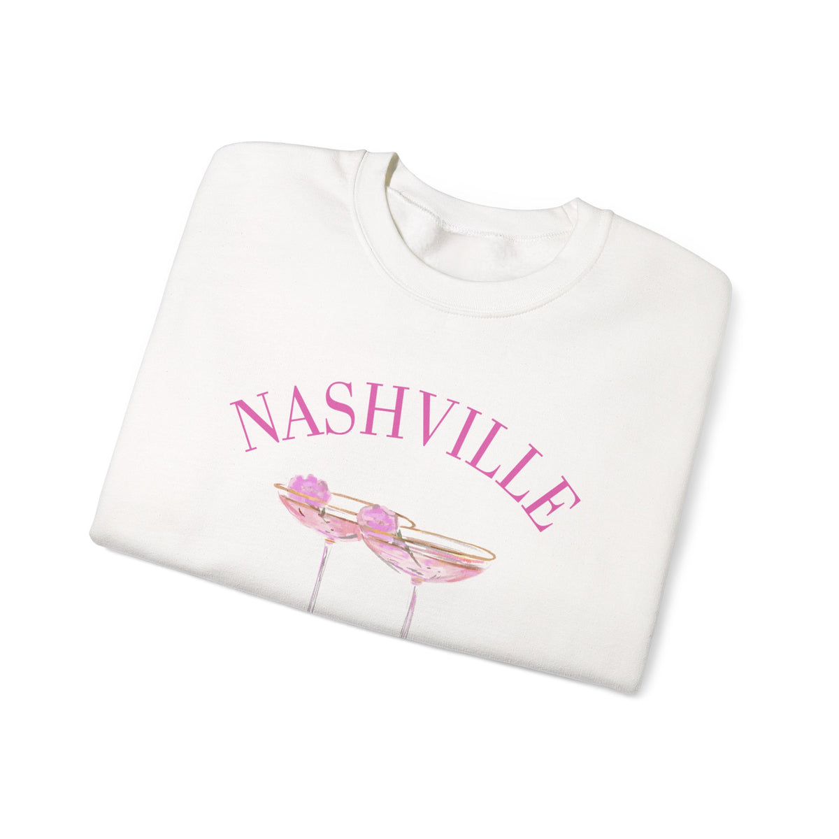 White crewneck sweatshirt with pink ‘Nashville’ bachelorette social club artwork featuring champagne coupe illustration, hand designed by Rebecca Illustrated