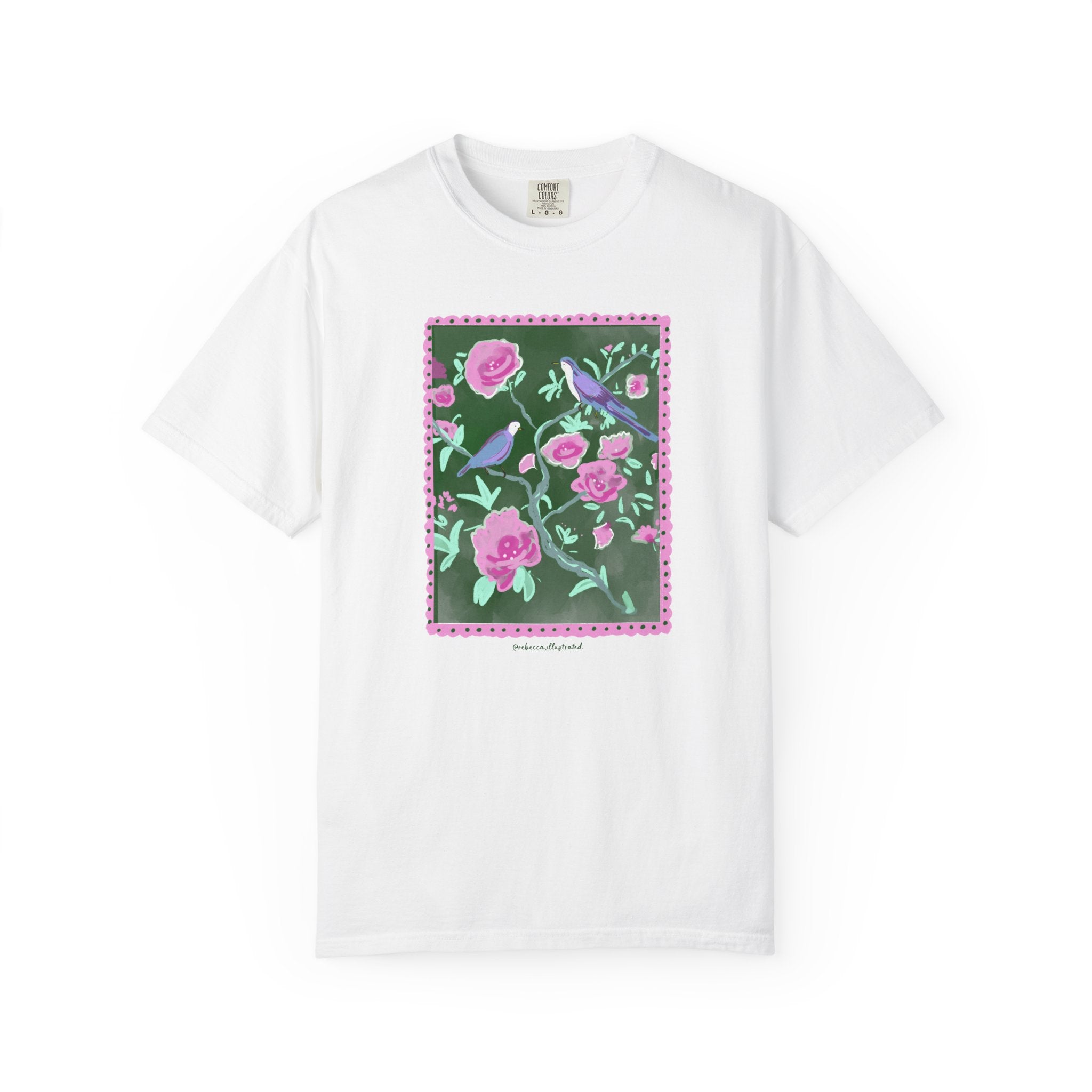 White t-shirt with a floral and bird design on a white background