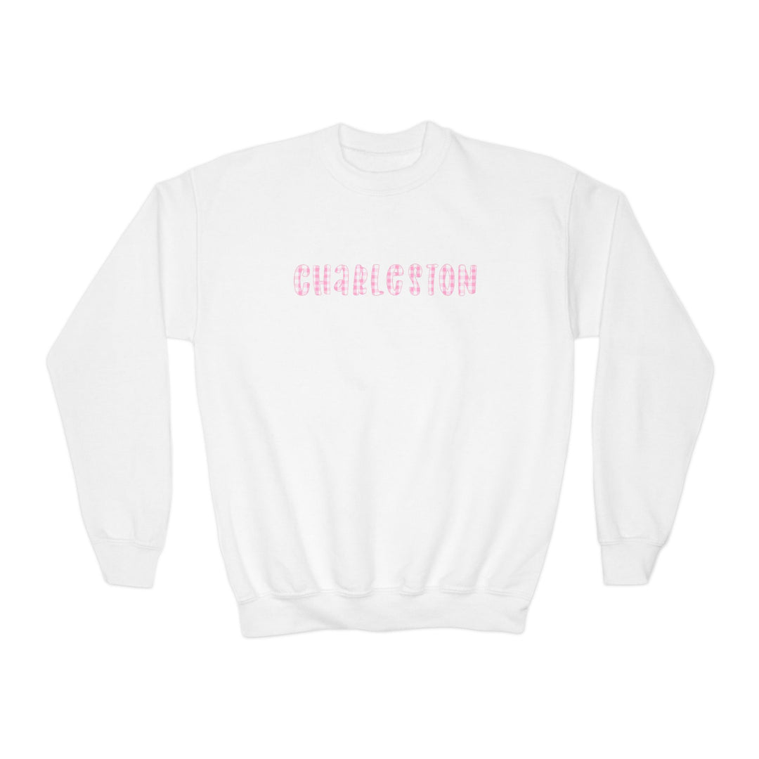Youth white crewneck sweatshirt featuring pink gingham ‘Charleston’ lettering on the front, illustrated by Rebecca Illustrated.