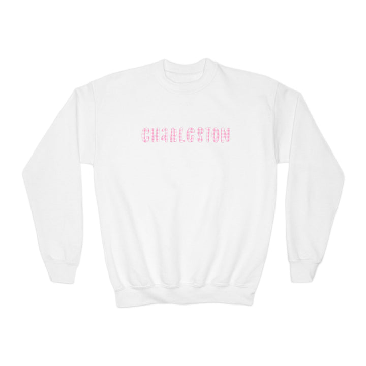 Youth white crewneck sweatshirt featuring pink gingham ‘Charleston’ lettering on the front, illustrated by Rebecca Illustrated.