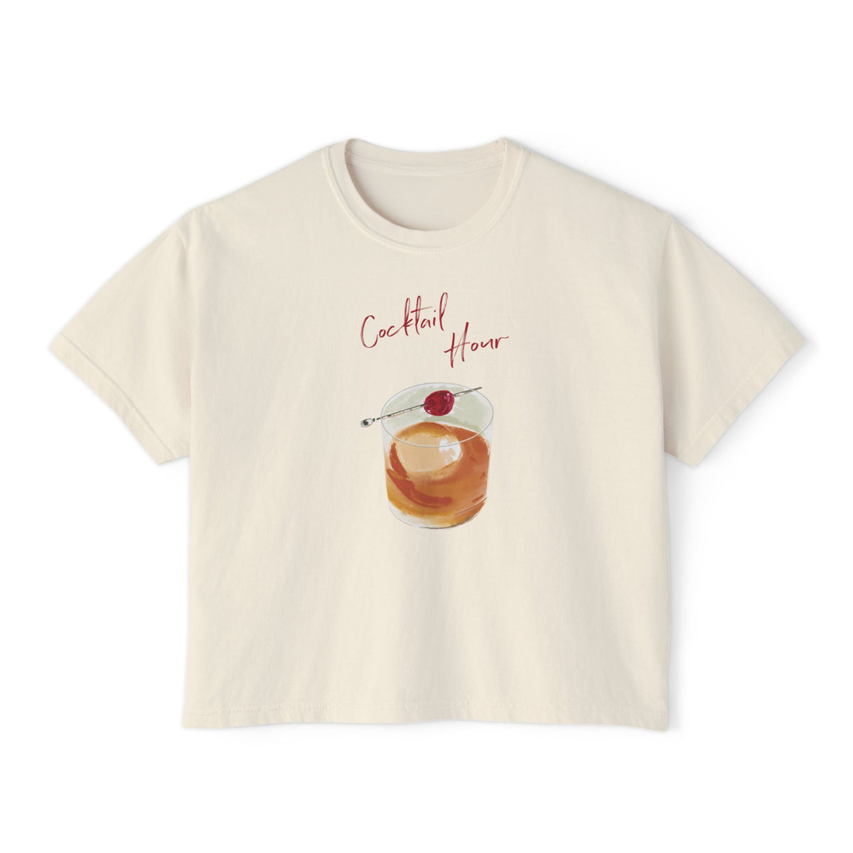 Cream t-shirt featuring a hand-drawn old fashioned cocktail with a cherry and the words “Cocktail Hour,” illustrated by artist Rebecca Illustrated