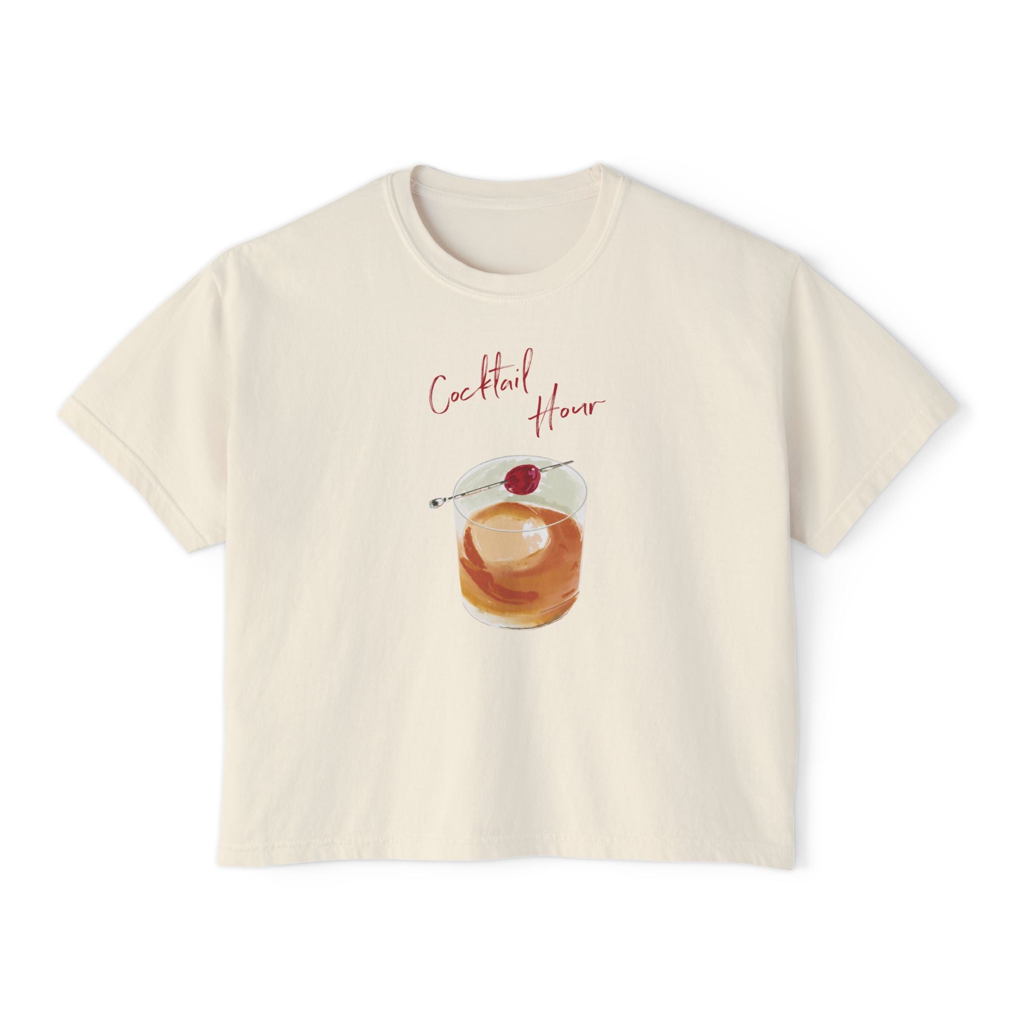 Cream t-shirt featuring a hand-drawn old fashioned cocktail with a cherry and the words “Cocktail Hour,” illustrated by artist Rebecca Illustrated