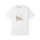 White t-shirt featuring a hand-drawn illustration of Church Street in Charleston, SC with palm trees, historic buildings, and pink floral accents, created by Rebecca Illustrated.