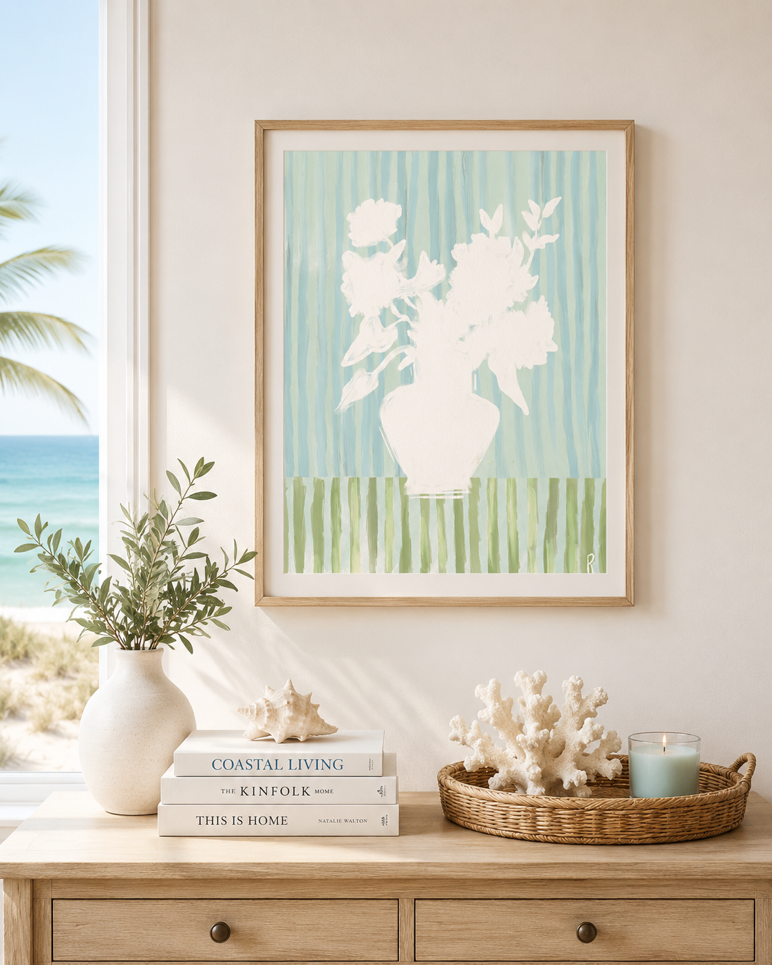Framed artwork of a vase with flowers on a wall above a wooden console table with decor items.