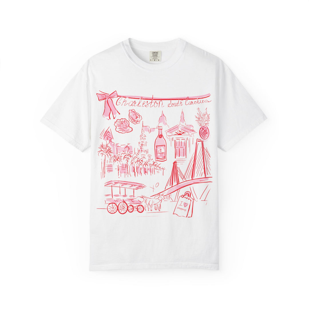 White graphic t-shirt featuring a hand-drawn coral pink illustration of Charleston, South Carolina landmarks including the Ravenel Bridge, historic buildings, church steeples, palm trees, oysters, pineapple, horse-drawn carriage, and Charleston-themed icons.