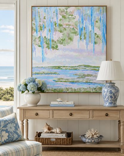 Living room with a large abstract landscape painting, floral arrangement, and decorative items.