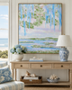 Living room with a large abstract landscape painting, floral arrangement, and decorative items.