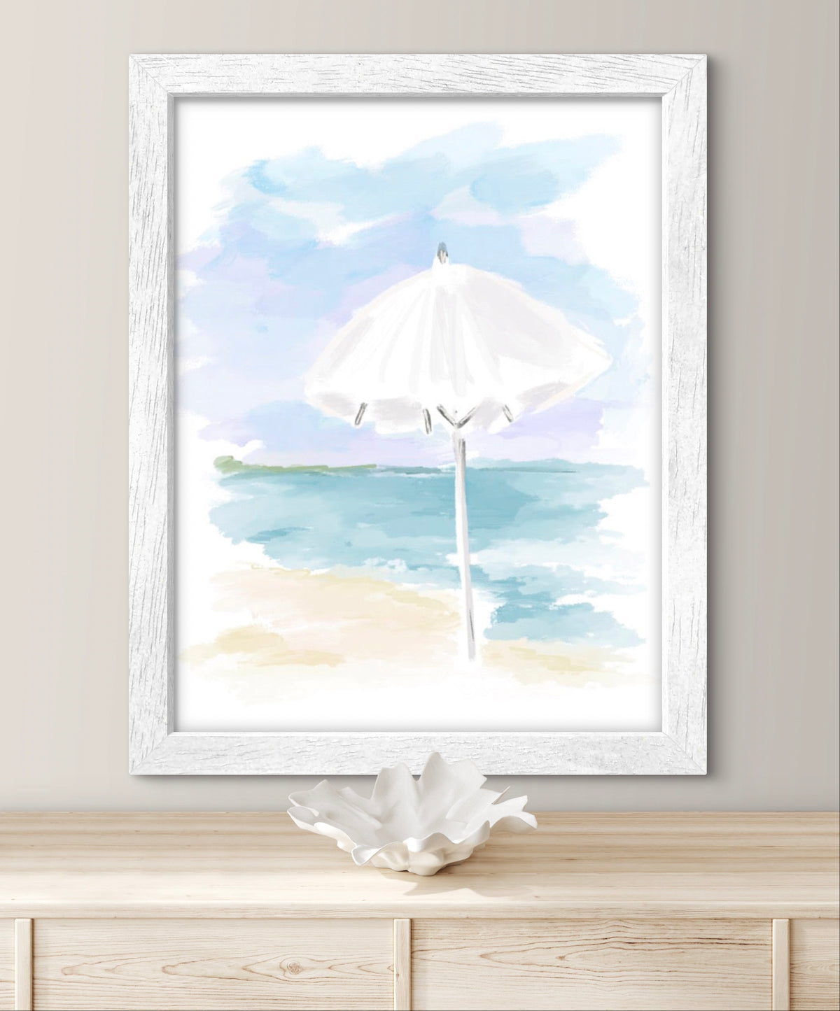 Soft pastel illustration of a white beach umbrella on a sandy shore with blue ocean waves by artist Rebecca Illustrated.