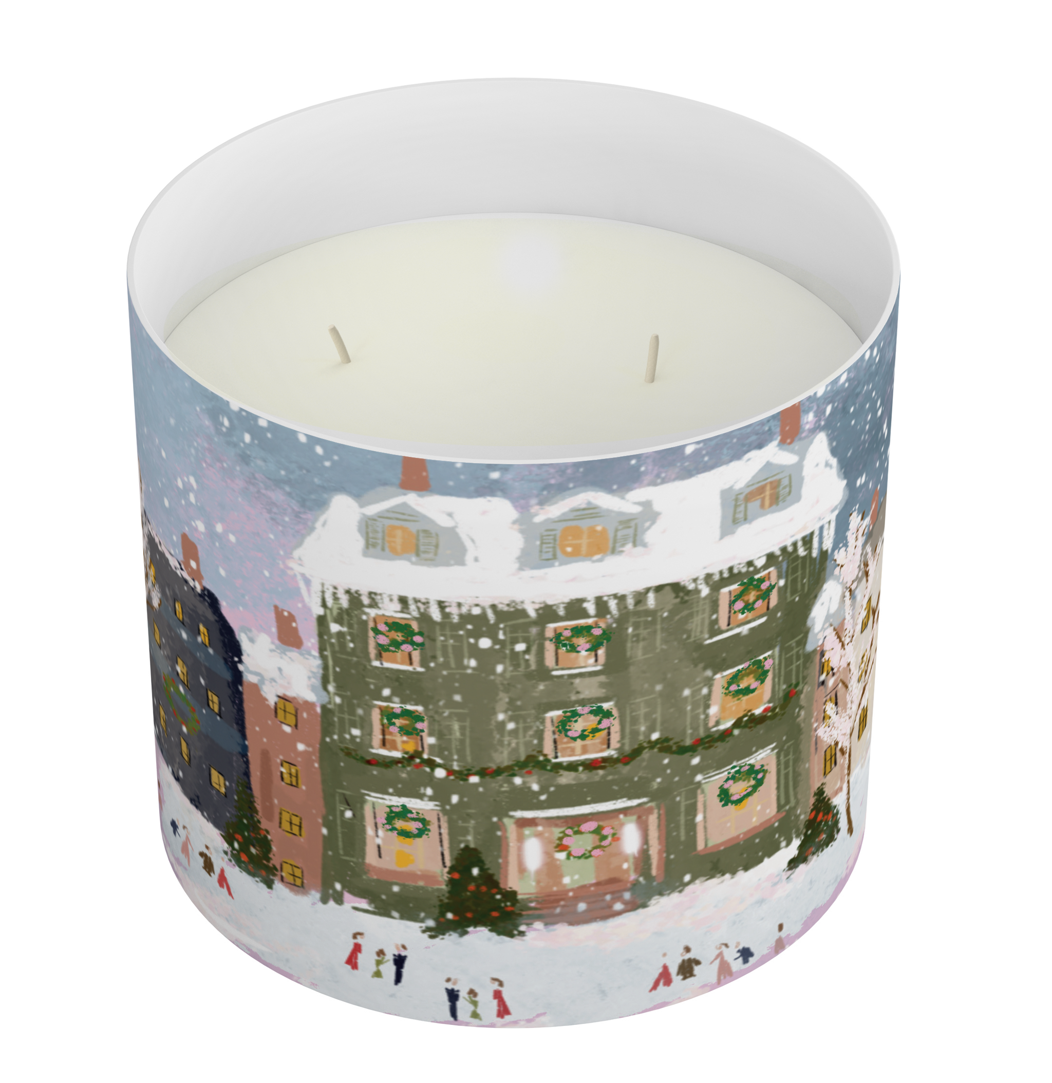 A large white jar candle with two wicks, featuring a detailed winter village illustration on the outside. The print shows snow-covered rooftops, decorated houses with green wreaths, and small figures of people walking in the snow.