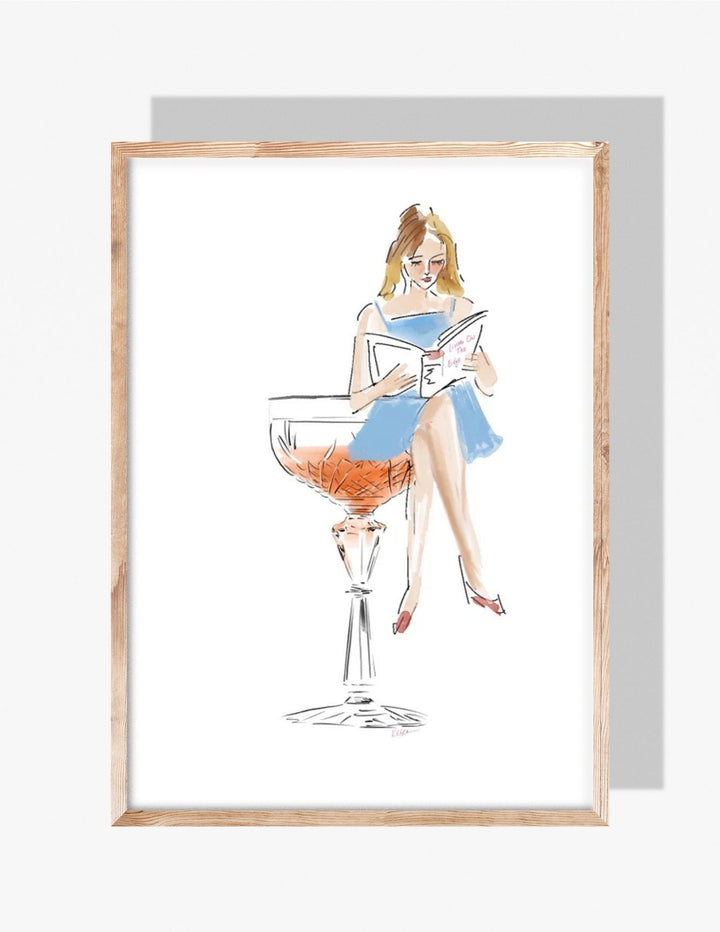 Illustration of a woman in a blue dress reading a book while sitting on the rim of a cocktail coupe glass filled with rosé.