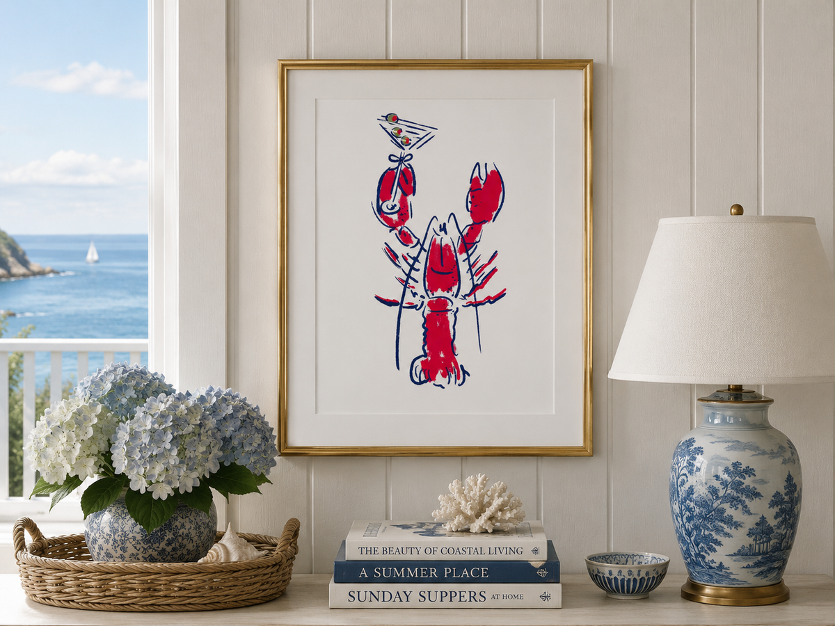 Framed artwork of a red lobster on a wall with a scenic view outside.