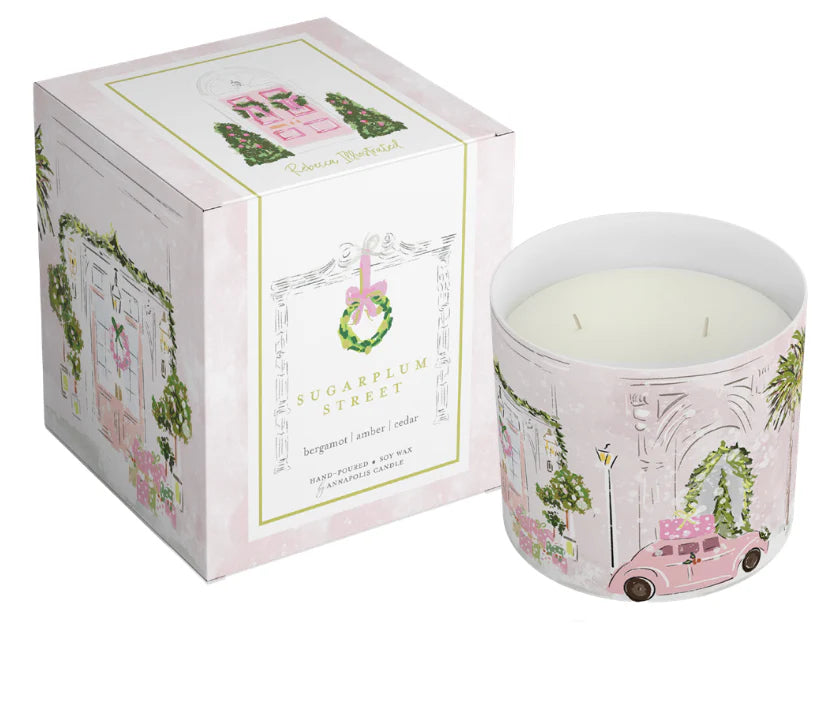 Luxury holiday candle with illustrated pink Christmas door and vintage car, boxed gift candle featuring original artwork by Rebecca Illustrated.