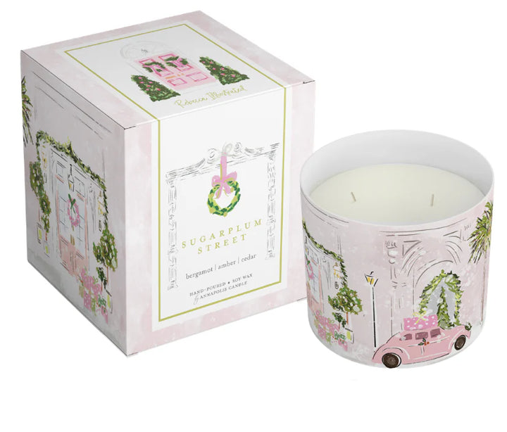 Luxury holiday candle with illustrated pink Christmas door and vintage car, boxed gift candle featuring original artwork by Rebecca Illustrated.