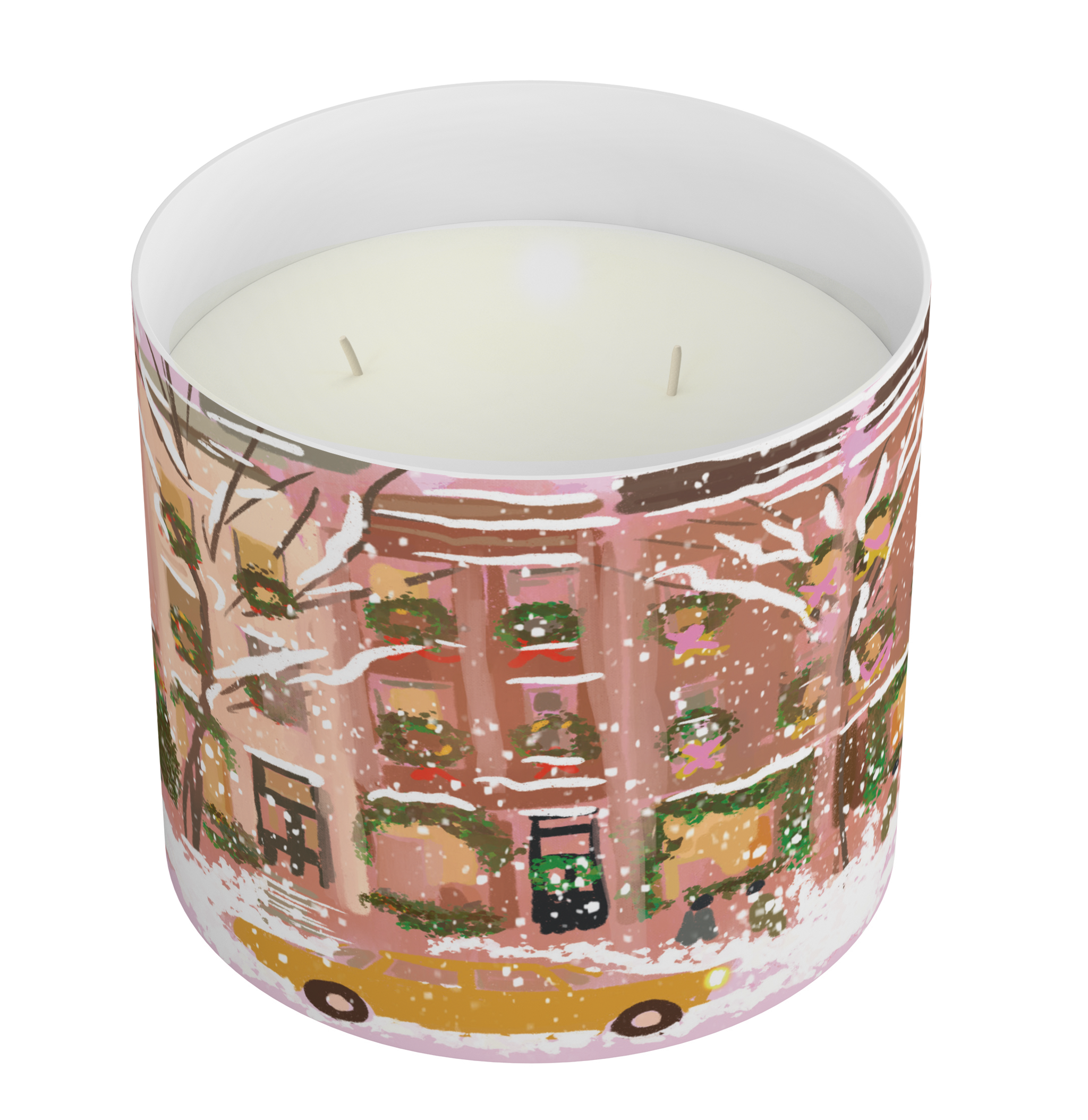 A two-wick scented candle in a cylindrical glass container with a winter cityscape illustration. The artwork features pink and brown building facades, snow-covered trees, green wreaths, and a yellow taxi at the bottom, set against a plain white background.