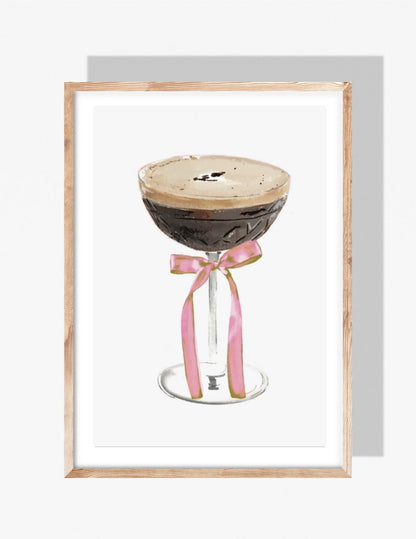 Watercolor illustration of an espresso martini in a coupe glass with a pink ribbon tied around the stem, by Rebecca Illustrated.