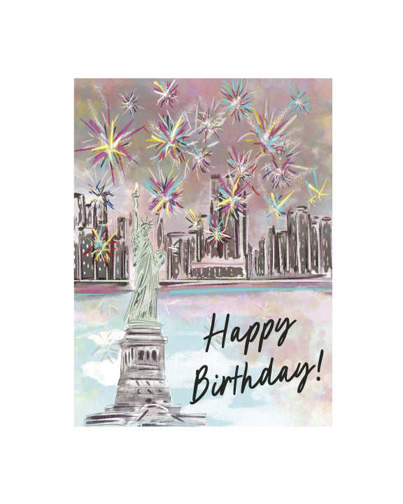 Illustrated birthday greeting card featuring the Statue of Liberty with New York City skyline and colorful fireworks, with “Happy Birthday!” text, by Rebecca Illustrated.