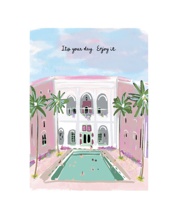 Illustrated greeting card featuring a pink villa with palm trees and a courtyard pool, with the phrase “It’s your day. Enjoy it.” by Rebecca Illustrated.