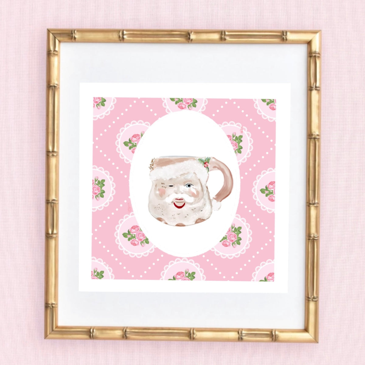 A whimsical illustration by Rebecca Illustrated of a vintage-style Santa face mug on a pink patterned background with roses and lace details, framed in a bamboo-style frame.